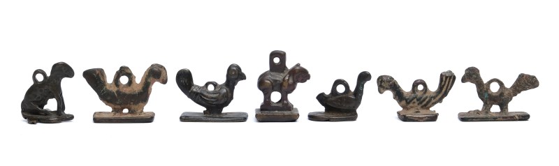 A group of seven small bronze seals as pendants