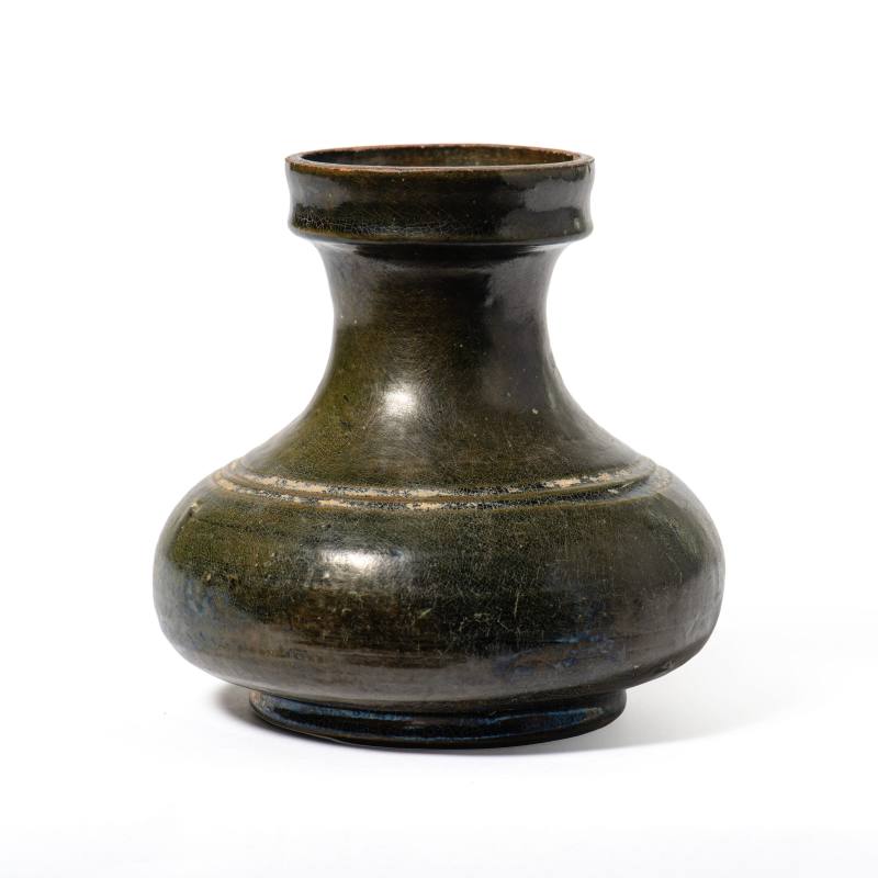 A dark green-glazed pottery jar