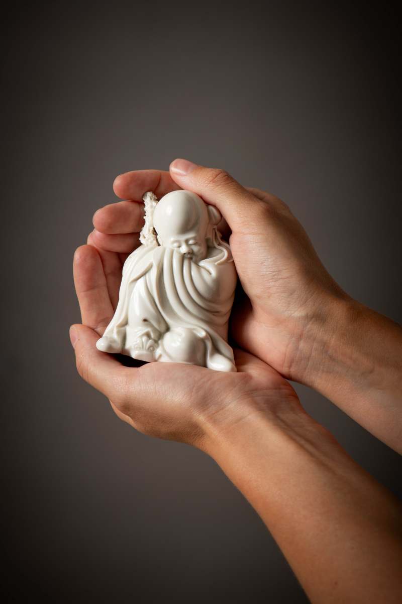 A Dehua white-glazed seated figure of Shoulao