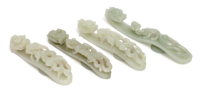 Four large pale celadon jade 'dragon' belt hooks