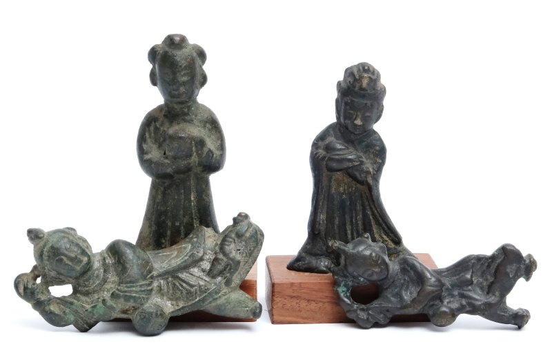 A group of four small bronze figures
