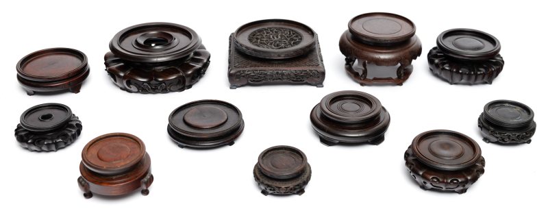 A group of twelve hardwood display stands