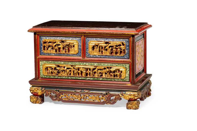 A wooden lacquered and gilded chest of drawers