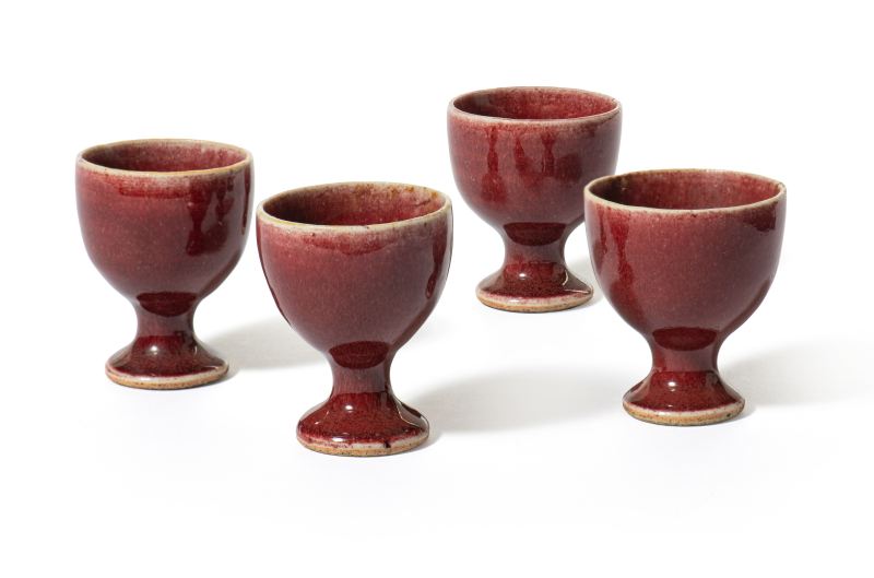 Four small copper-red glazed stem/wine cups