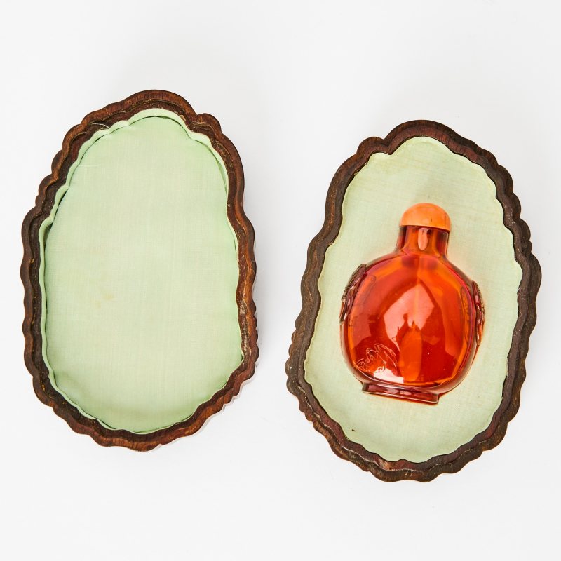 A Chinese Carved Amber Snuff Bottle with a Zitan Box
