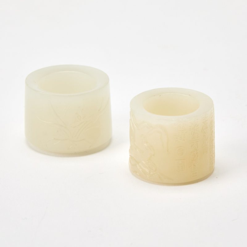 Two Chinese Carved White Jade Thumb Rings