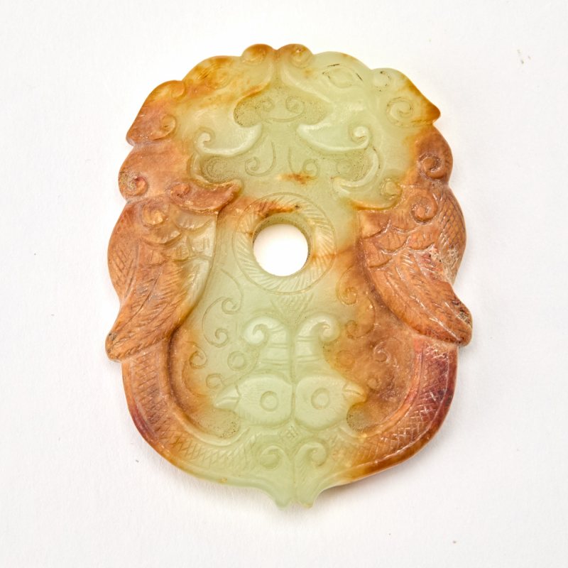 A Chinese Carved Celadon and Russet Jade Pendant