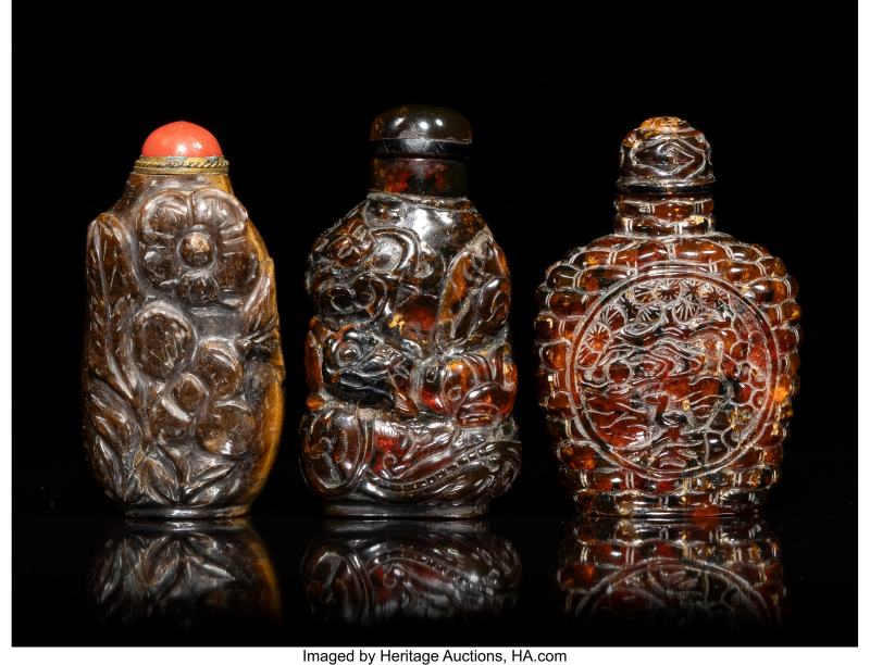 Two Chinese Carved Amber and A Tiger's Eye Snuff Bottles