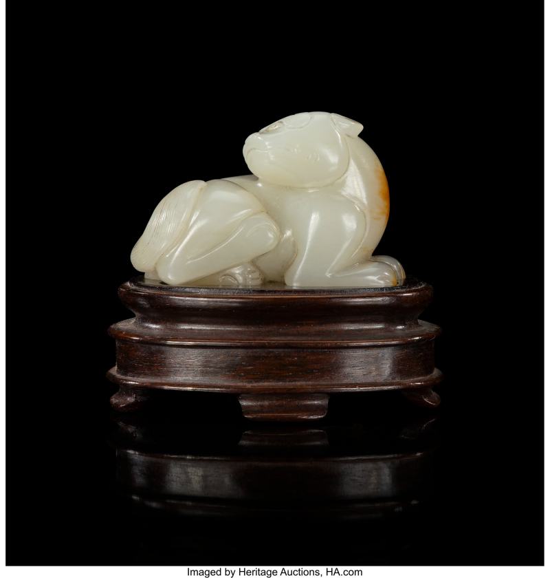 A Chinese Carved Russet Pale Celadon Jade Figure of a Recumbent Animal