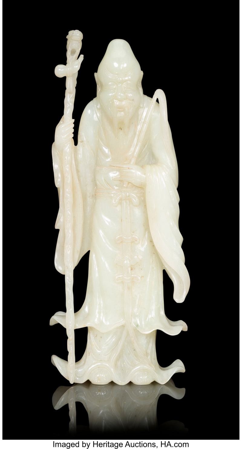 A Chinese Carved White Jade Figure of Shoulao with Staff