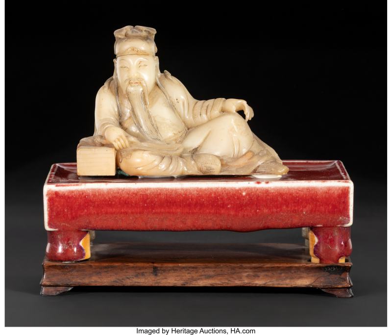 A Chinese Carved Soapstone Figure of a Reclining Scholar