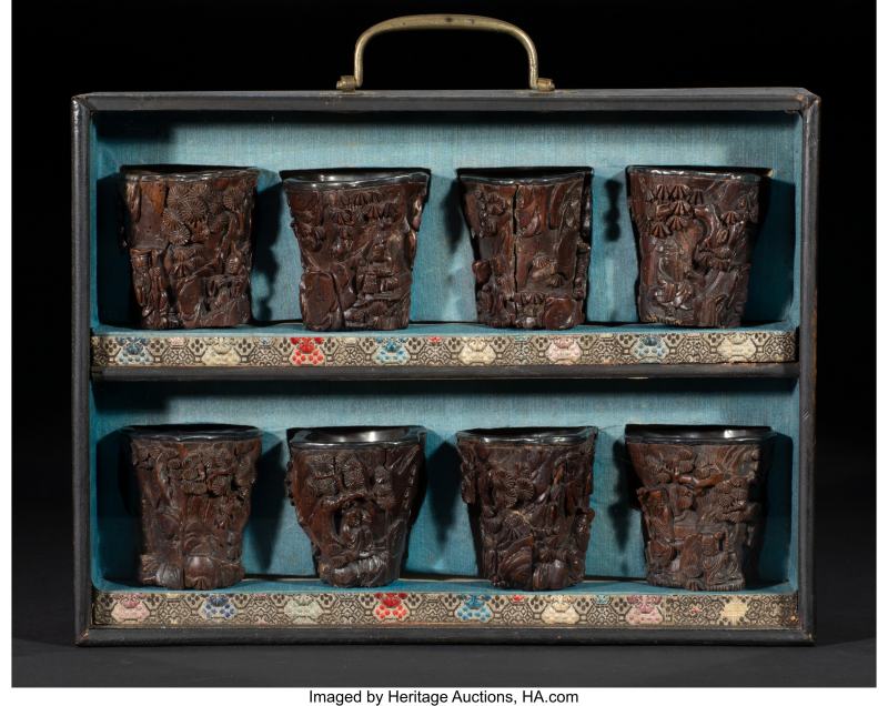 A Group of Eight Chinese Silver-Inlaid and Carved Agarwood Cups Accompanied by Fitted Case