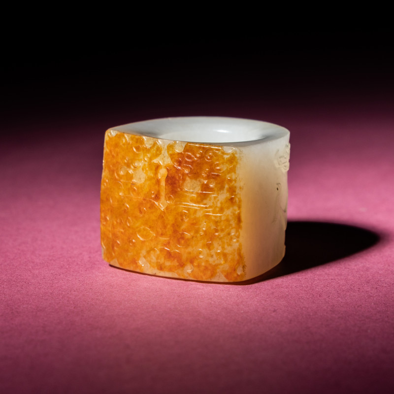 清中期 白玉留皮饕餮螭龍紋扳指 | A Chinese Russet and White Jade 'Taotie and Chilong' Archer's Ring, 18th Century