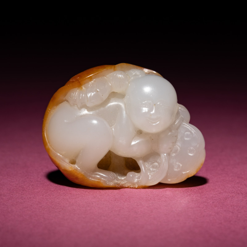 清中期 白玉留皮童子持荷把件 | A Chinese Russet and White Jade Carving of a Boy with Lotus Pad, 18th/19th Century