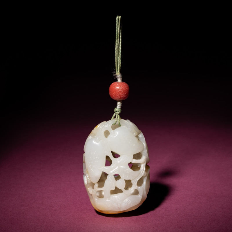 清中期 白玉帶皮鏤雕石榴荔枝佩 | A Chinese Russet and White Jade Reticulated Pendant, 18th/19th Century