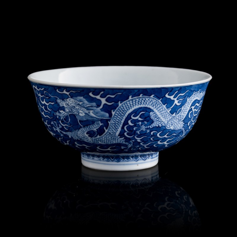 清光緒 青花地留白龍紋碗（附錦盒） | A Chinese blue-ground and white-reserved 'dragon' bowl, Guangxu period, Qing dynasty