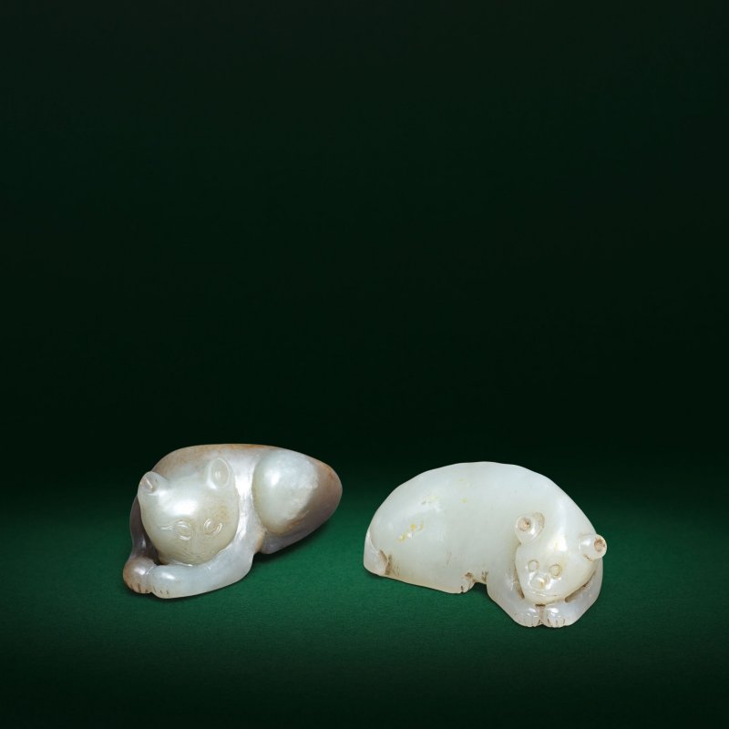 清 褐青玉貓兩件 | TWO PALE GREEN AND BROWN JADE RECUMBENT CAT CARVINGS
