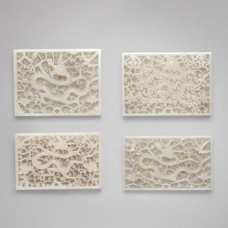 明 白玉鏤雕穿花龍紋帶板 一組四件 | A GROUP OF FOUR WHITE JADE RETICULATED 'DRAGON' BELT PLAQUES