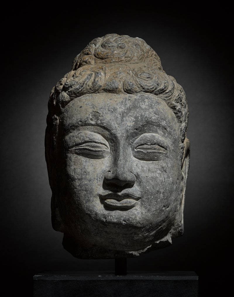 A rare grey limestone head of Buddha, Early Tang dynasty | 唐初 石灰石雕佛首