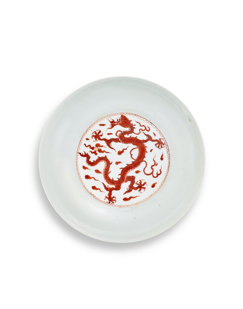 A fine iron-red decorated and incised 'dragon and phoenix' dish, Qing dynasty, Kangxi period, Xuande mark | 清康熙　礬紅暗刻龍鳳紋盤　《大明宣德年製》暗刻仿款