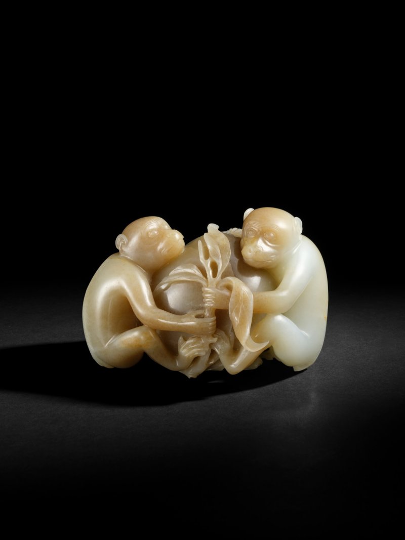 A large brown and white jade ‘monkey and peach’ group, Qing dynasty, 18th century | 清十八世紀　玉雕靈猴獻壽