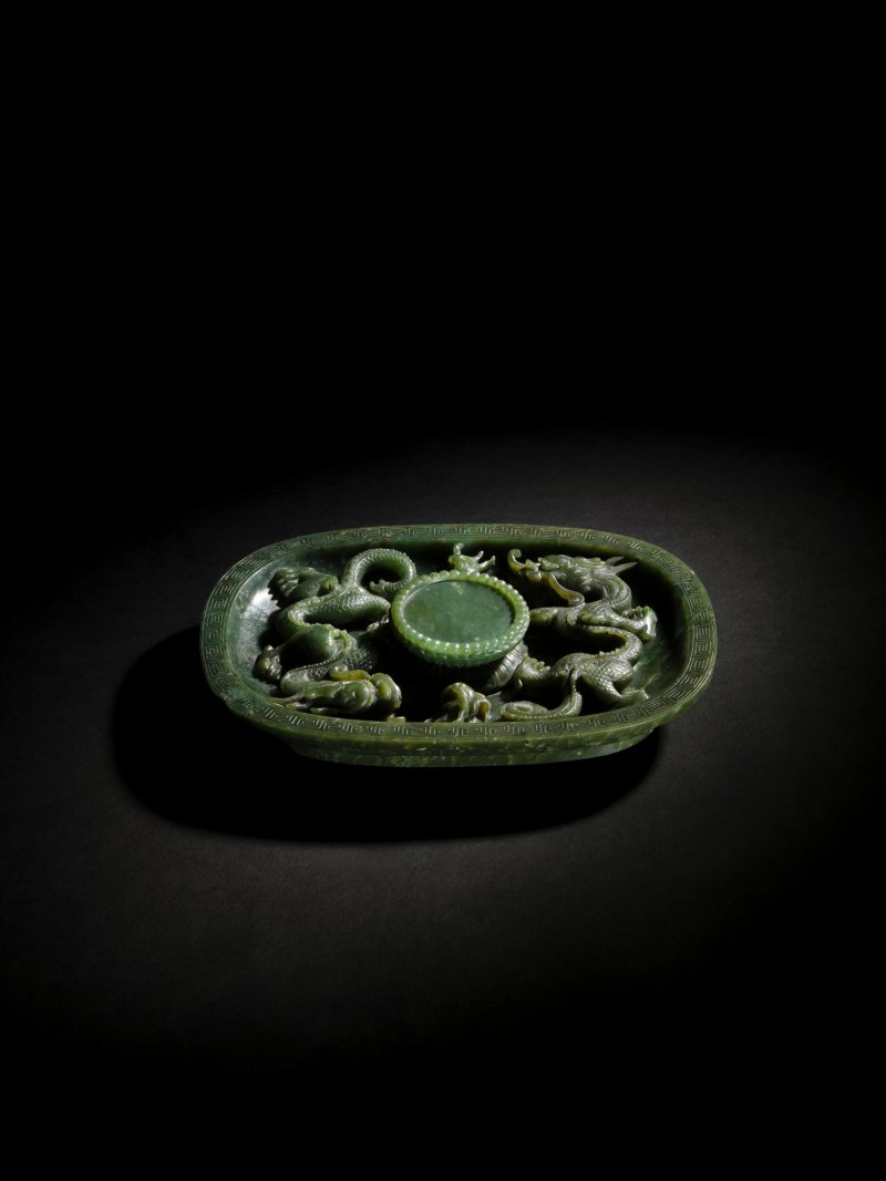 A spinach-green jade 'dragon' cupstand, Qing dynasty, Qianlong period | 清乾隆 碧玉趕珠龍紋盃托