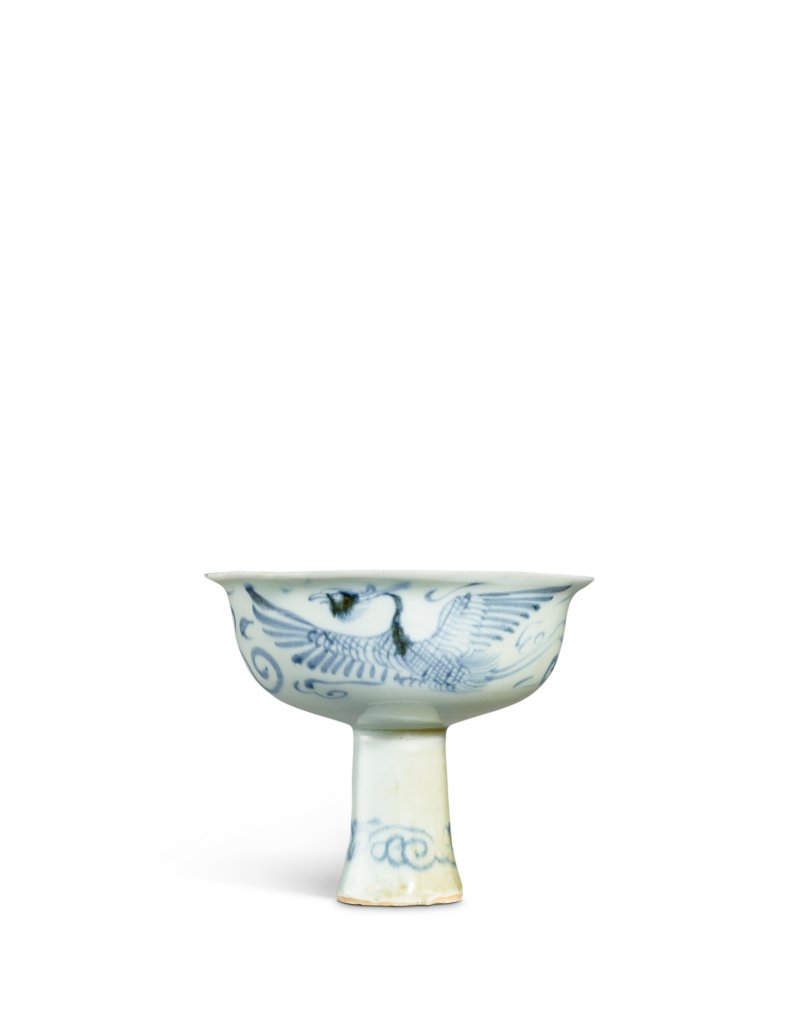 A rare blue and white moulded 'dragon and phoenix' stem cup, Yuan dynasty | 元　青花模印龍鳳紋壽字高足盃