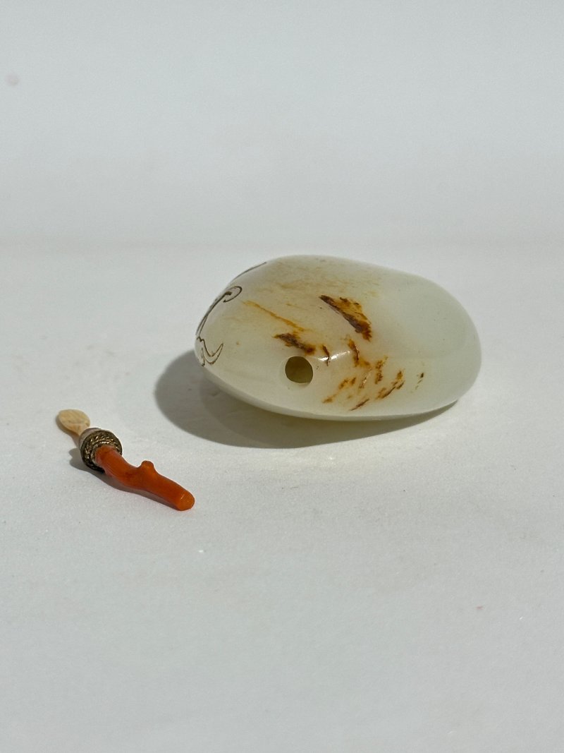 十九/二十世紀 白玉褐沁隨形祥雲蝠紋鼻煙壺、珊瑚蓋 | A WHITE AND RUSSET JADE PEBBLE-SHAPED SNUFF BOTTLE - 图4