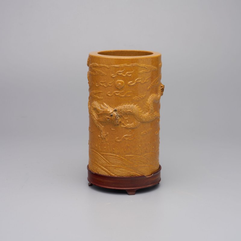 民國 黃釉澀胎浮雕龍紋筆筒 及座 | A CARVED YELLOW-GLAZED BISCUIT 'DRAGON' BRUSH POT