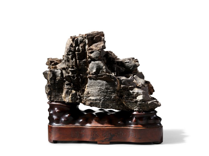 The Ruan Yuan–Duanfang ‘Vulture Crag’ scholar’s rock, Ming dynasty;  the rock inscribed by Ruan Yuan, dated the first year of the Jiaqing reign (1796); the accompanying wood stand inscribed Taozhai qinggong and Duanfang |  明　「鷲巖」石供　清嘉慶元年（1796年）　 阮元題銘　  木座「陶齋清供」、「端方」款