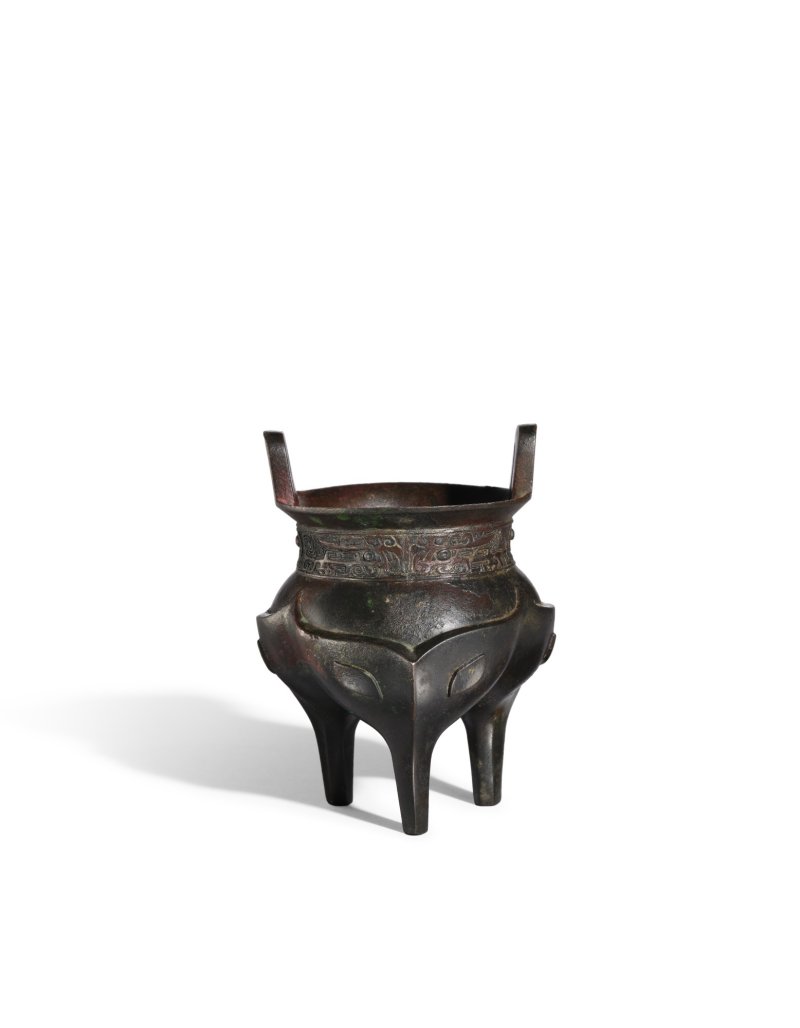 A small bronze ‘taotie’ tripod incense burner, Ming dynasty| 明　銅沖耳獸面三足鬲式爐 - 图1