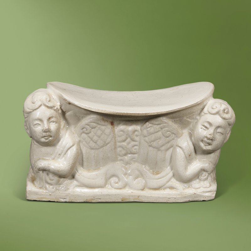 A DING WHITE-GLAZED MOULDED 'KALAVINKA' PILLOW  CHINA, NORTHERN SONG-JIN DYNASTY (960-1234)