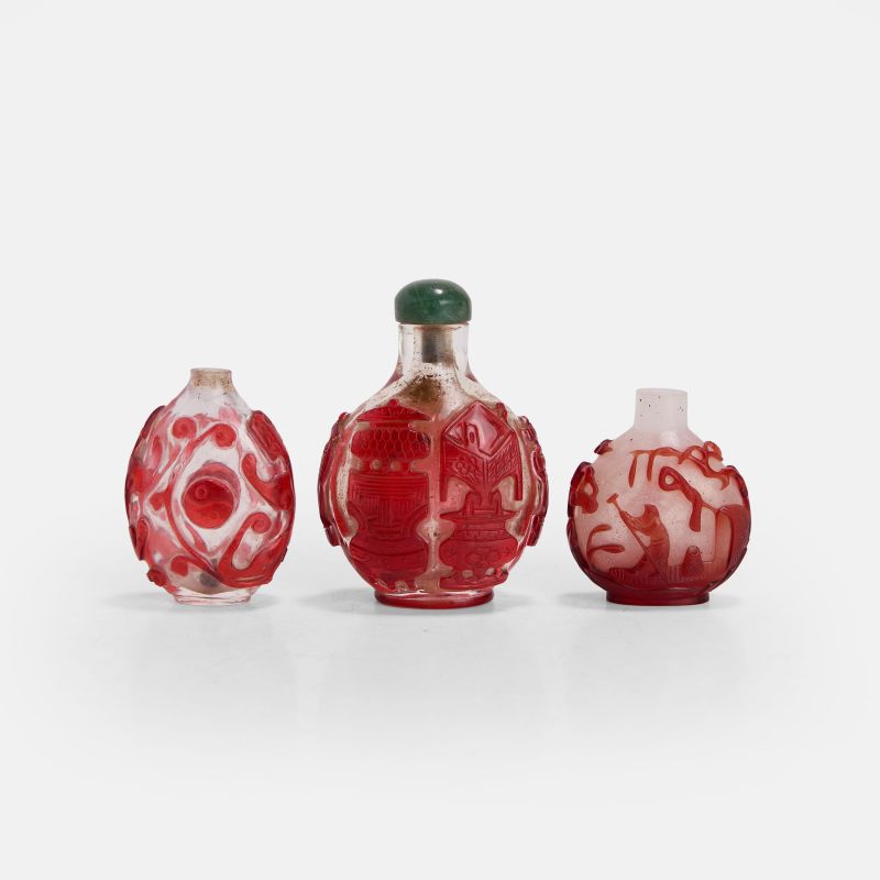 清晚期 套红料鼻烟壶 一组三件 | Three Chinese red-overlaid Peking glass snuff bottles late Qing dynasty, comprising:
one carved with a fisherman punting a boat - 图2