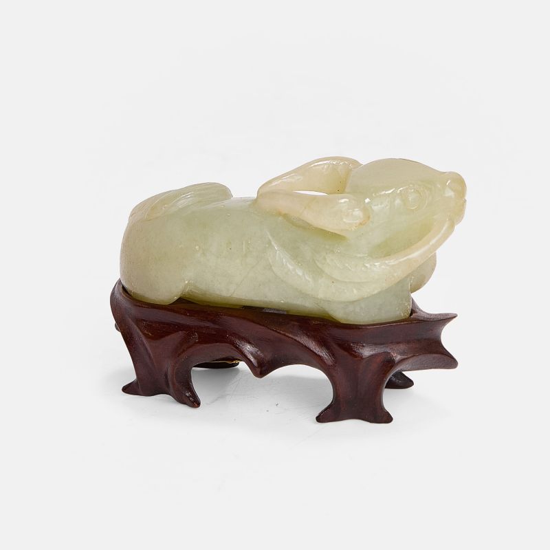 清 玉牛摆件 连木底座 | A Chinese jade carving Qing dynasty (1644-1911), of a recumbent buffalo