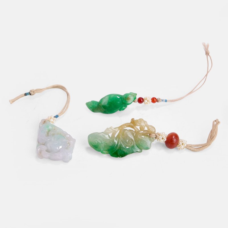 清 翡翠喜上眉梢珮、灵猴献寿珮、及宝鸭穿莲珮 一组三件 | Three Chinese jadeite pendants Qing dynasty (1644-1911), comprising:
one with a magpie holding a blossoming prunus branch in its beak