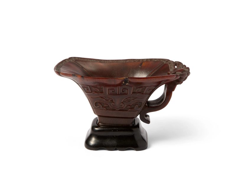 清十八世紀 犀角雕仿古饕餮獸面紋杯連木座 | A Chinese archaistic rhinoceros horn libation cup