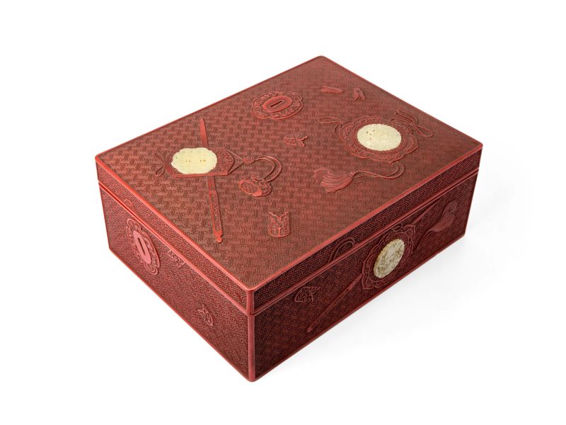 A large Japanese jade-inset carved cinnabar lacquer box and cover