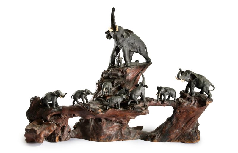 A Japanese bronze okimono group of elephants with fitted wood stand
